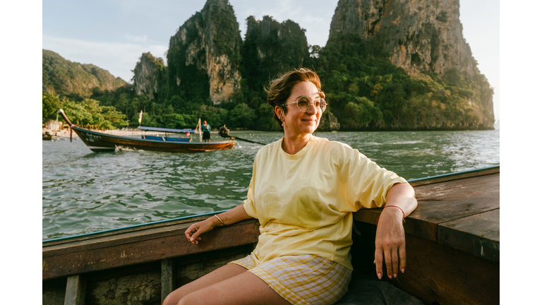 A mature woman sitting on the boat