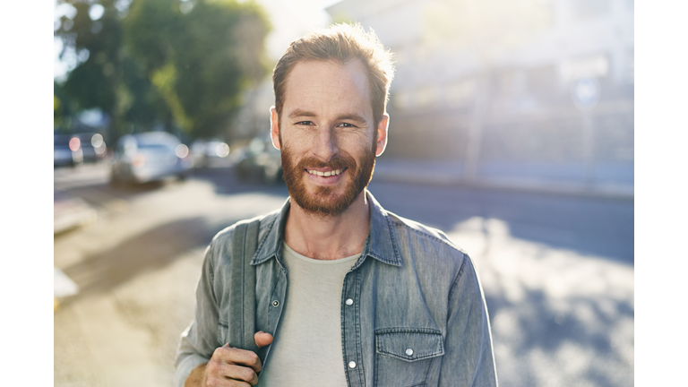 Smiling young man on the street