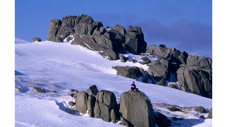 Climber on boulder, Snowy Mountains.