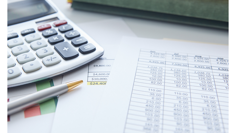 Close-up of a tax form with calculator and a pen