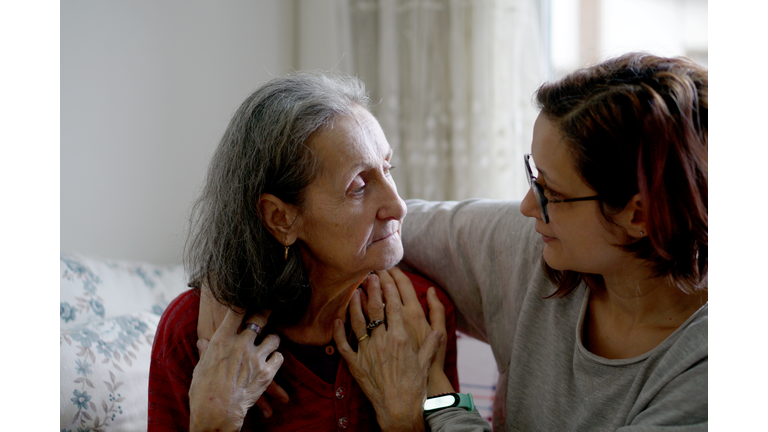 Woman hugging her elderly mother