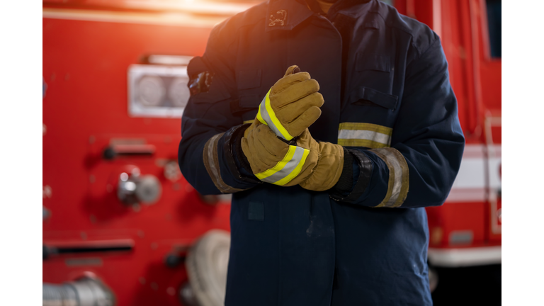 Fireman with gas mask and helmet at fire station.