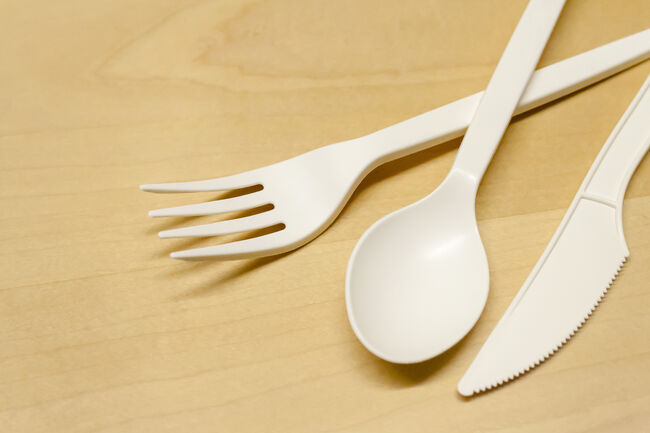 plastic spoon and fork on a wooden table