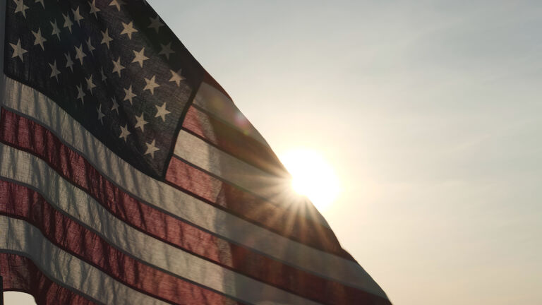Concept of Memorial Day, Remember and Honor, 4th of July, Independence Day, Veteran Day, Holiday, Celebration. American USA flag waving in sunset outdoor background for honoring, mourning USA military