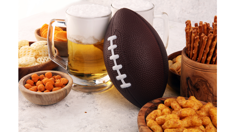 Chips, salty snacks, football and Beer on a table. Great for Bowl Game snack projects.