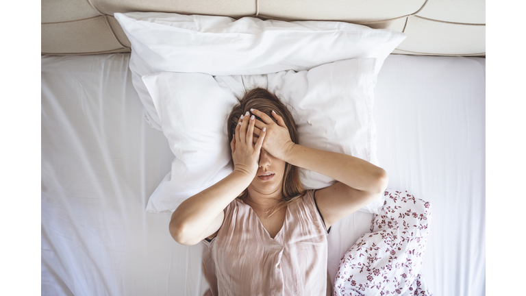 Desperate girl suffering insomnia trying to sleep