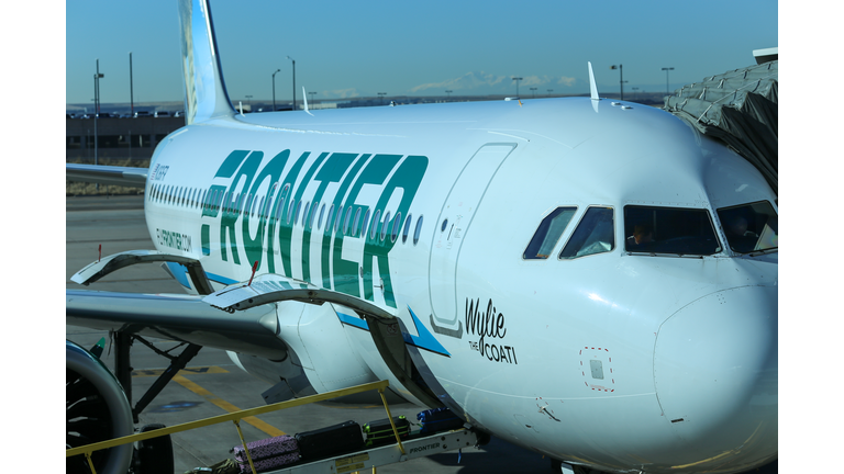 Frontier Airlines Jet Airline at gate in daytime
