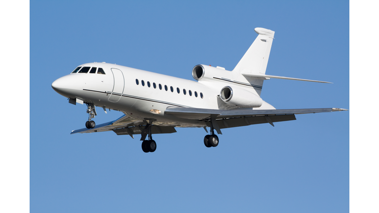 Corporate aircraft flying in a clear blue sky