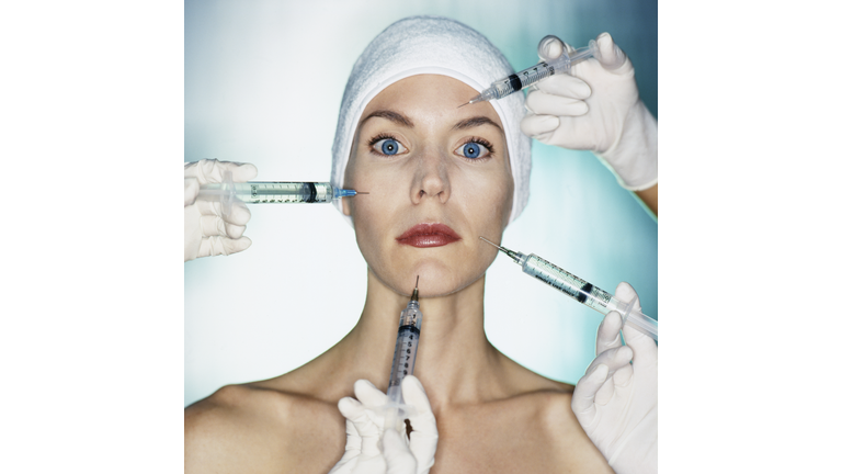 Mixed race woman having facial injections