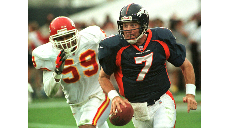 Denver Broncos quarterback John Elway scrambles fo