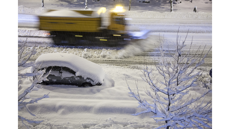 Snowplow removing new snow at night