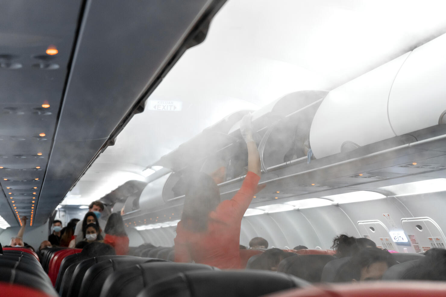 The aircraft cabin before departure. Boarding passengers. Air travel during the coronavirus pandemic.