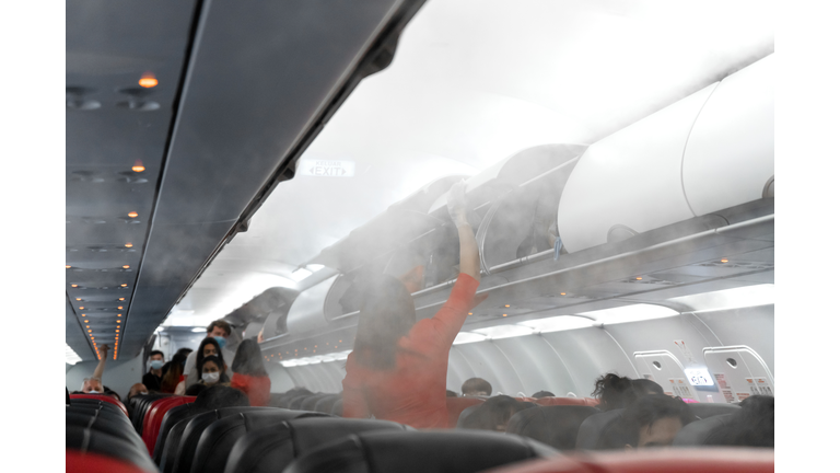 The aircraft cabin before departure. Boarding passengers. Air travel during the coronavirus pandemic.