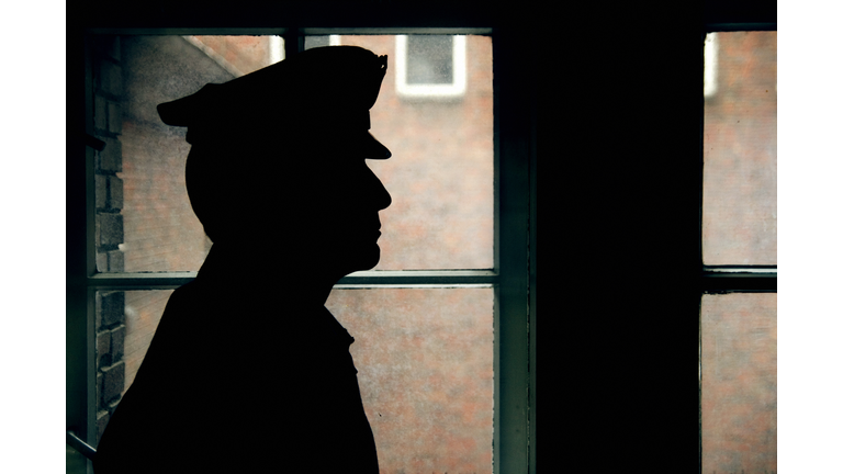 Silhouette of a prison/police warden