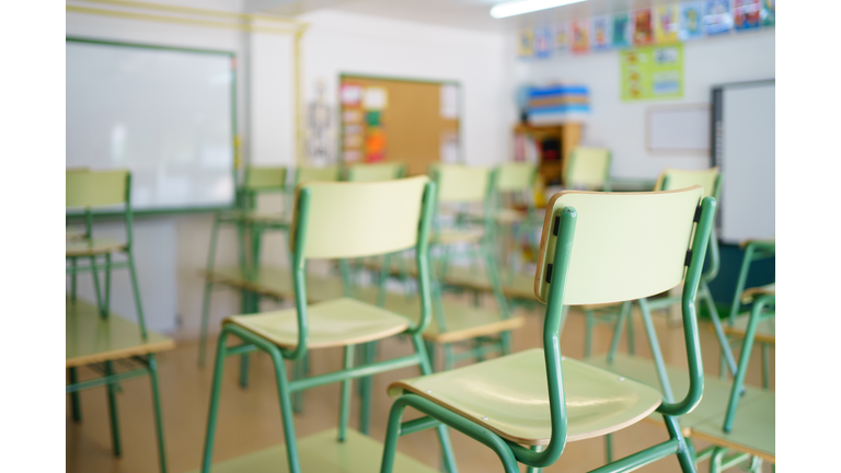 Close-up of a chair on a student's desk inside a classroom in a secondary school.