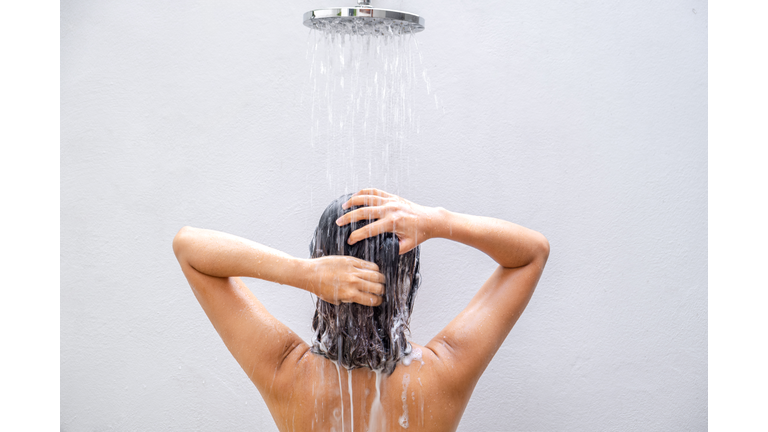 Beautiful woman's hand She was washing her hair and nourishing her scalp. Shampoo and conditioner