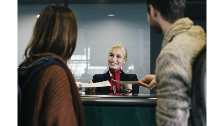 Young Traveller Couple At Check-In Counter