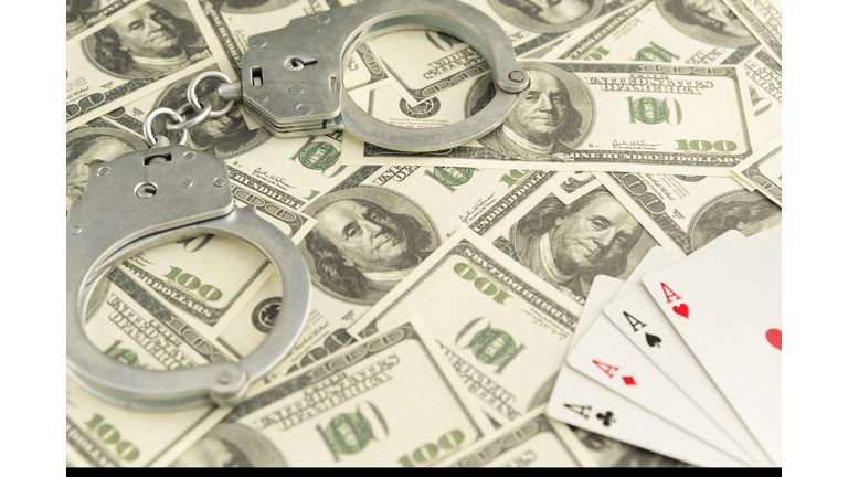 handcuffs, banknotes of dollars, four ace of playing cards.