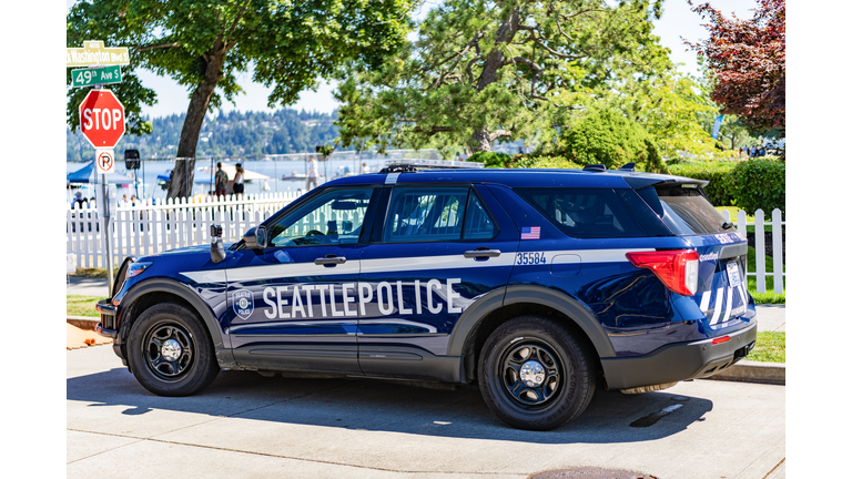 Blue and white Seattle police car parked on street. Seattle state police.