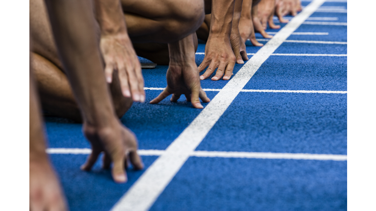 Track sprinters lined up at starting