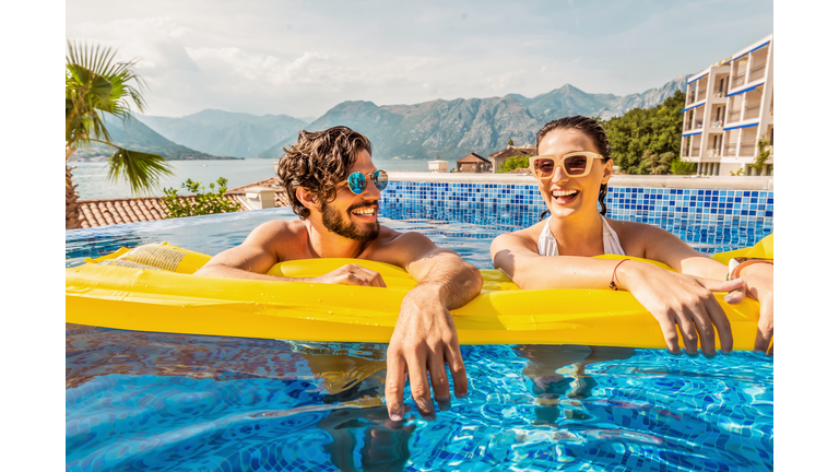 playful couple smiling in a pool