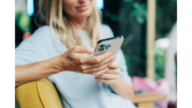 Close-up of a mobile phone in the hands of an unrecognizable person.