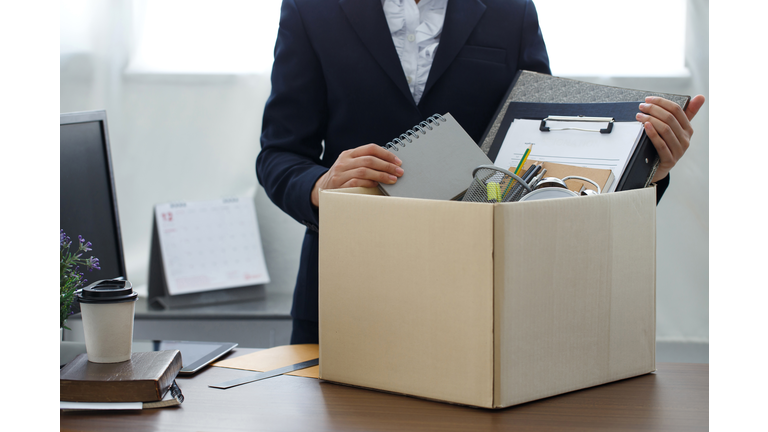 Resignation concept.Businesswoman packing personal company belongings when she deciding resignation change of job or fired from the company.