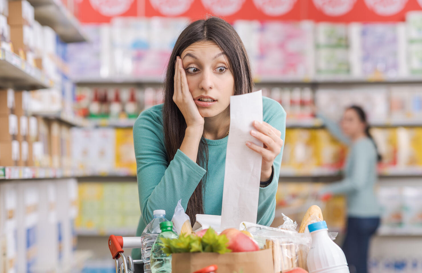 Woman checking an expensive grocery receipt