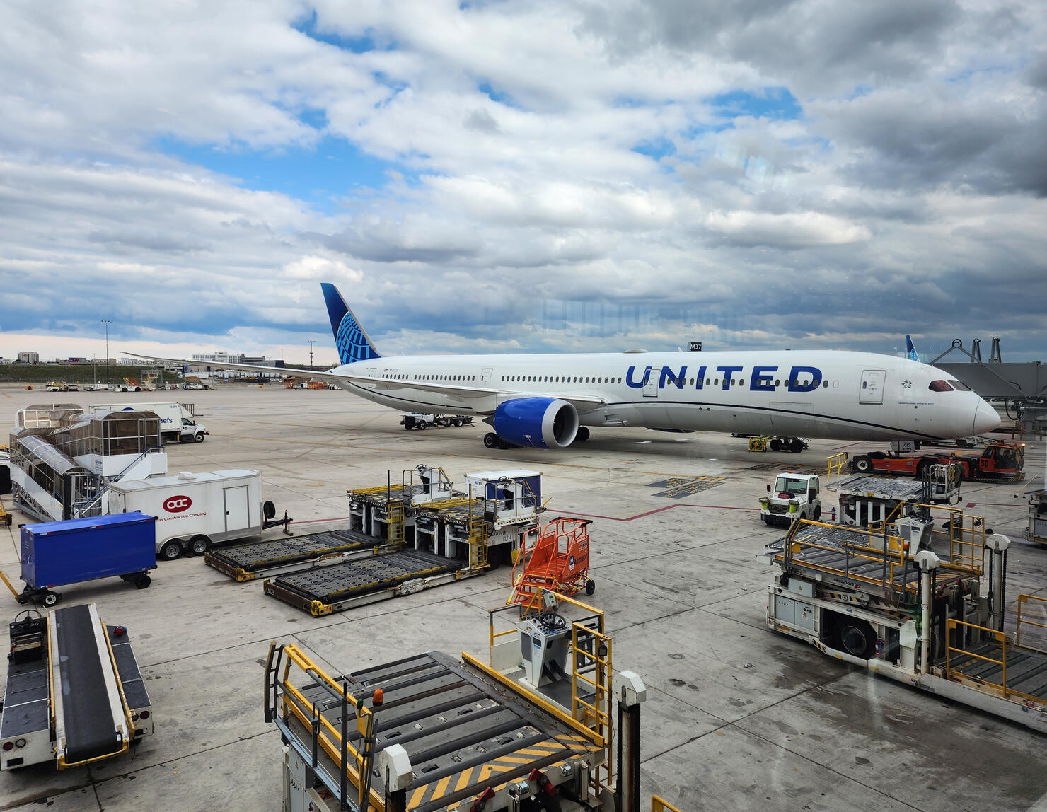 Boeing 787-300ER united airlines at airport with baggage loader