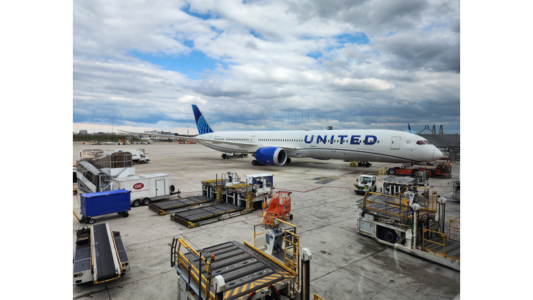 Boeing 787-300ER united airlines at airport with baggage loader