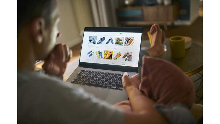 Man purchasing shoes on an online shop