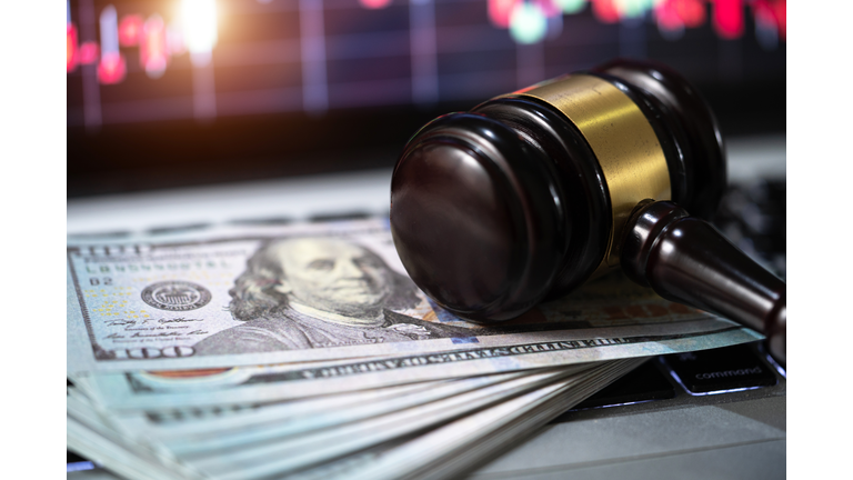 investment concept,US paper currency on Laptop and gavel,Money with a hammer