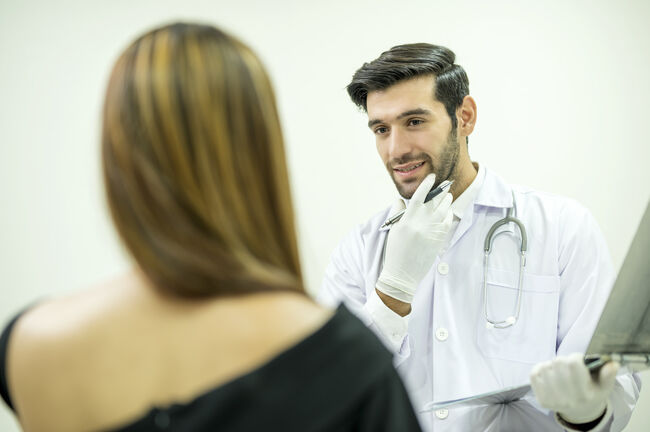 Cosmetic surgeon explaining patients face for surgery. Medical consultations, Plastic Surgery Clinic Business.