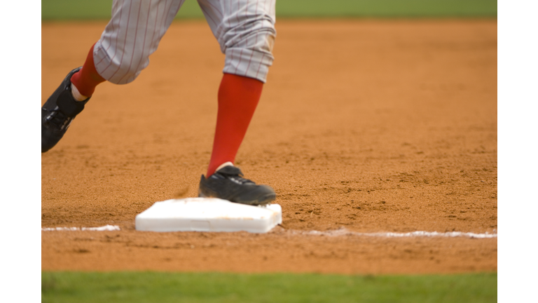 Baseball Player Running to First Baseball during Baseball Game