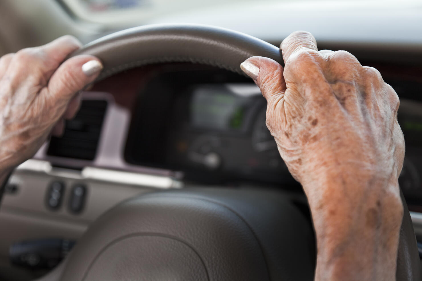 senior woman hands, driving car, steering wheel