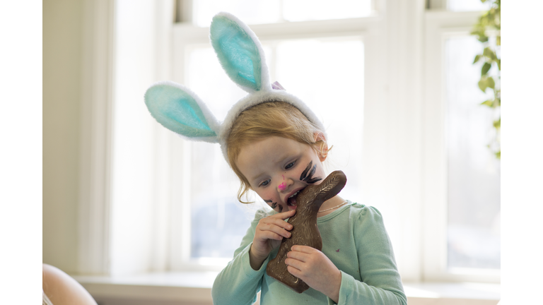 Biting a Chocolate Easter Bunny