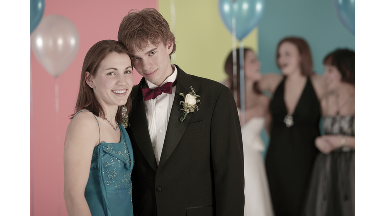 Portrait of teenage couple at prom