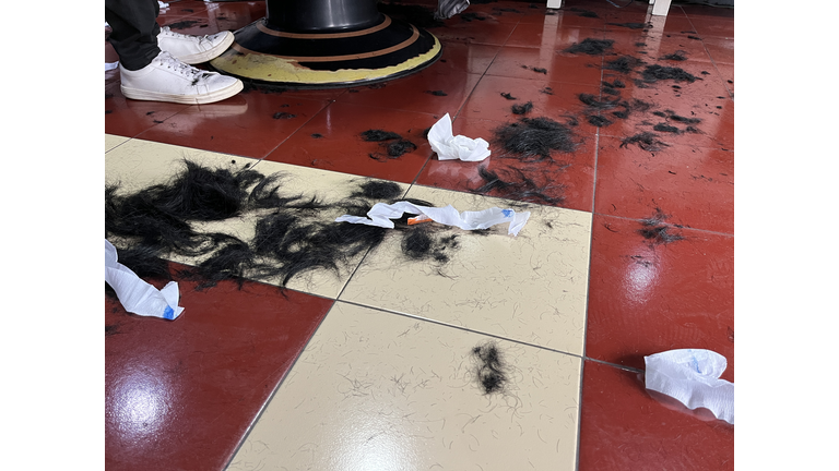 Cut hair on the floor in a barbershop.