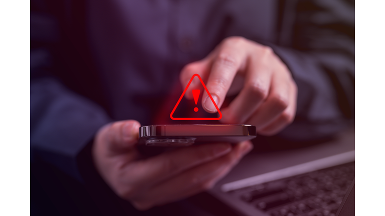 People with warning notification and spam message icon on mobile phone