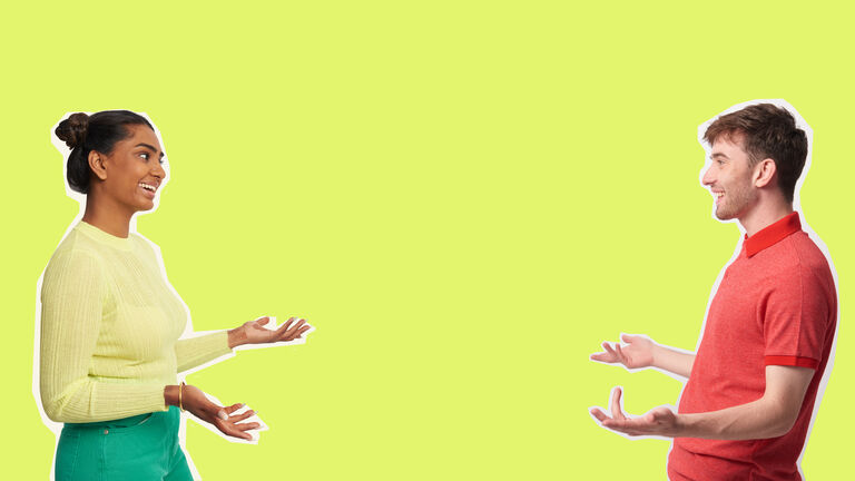 young man and woman having conversation against yellow background