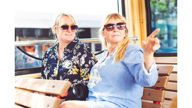 Two women, mother and adult daughter enjoying a tour on a vacation together
