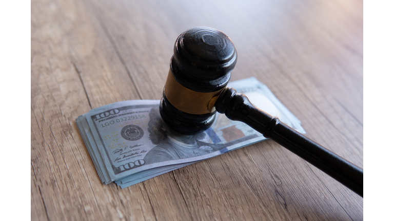 Closeup image of gavel and money.