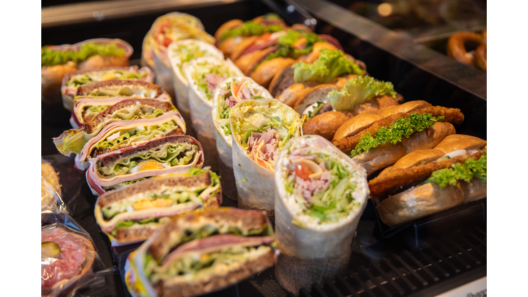 Various snacks, sandwiches with ham, salad, cheese and butter