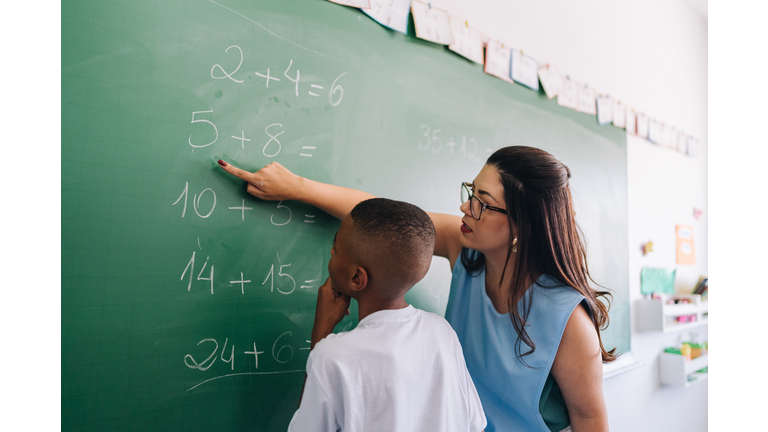 Teacher teaching the student on classroom at school