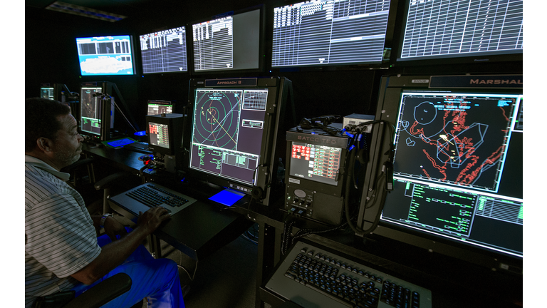 An Air Traffic Controller monitors compu