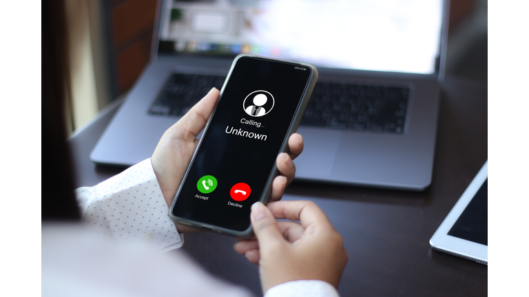 Unknown number displayed showing on smart mobile phone. Human use smartphone with incoming call from unknown number, spam, hacker, call center, crime,