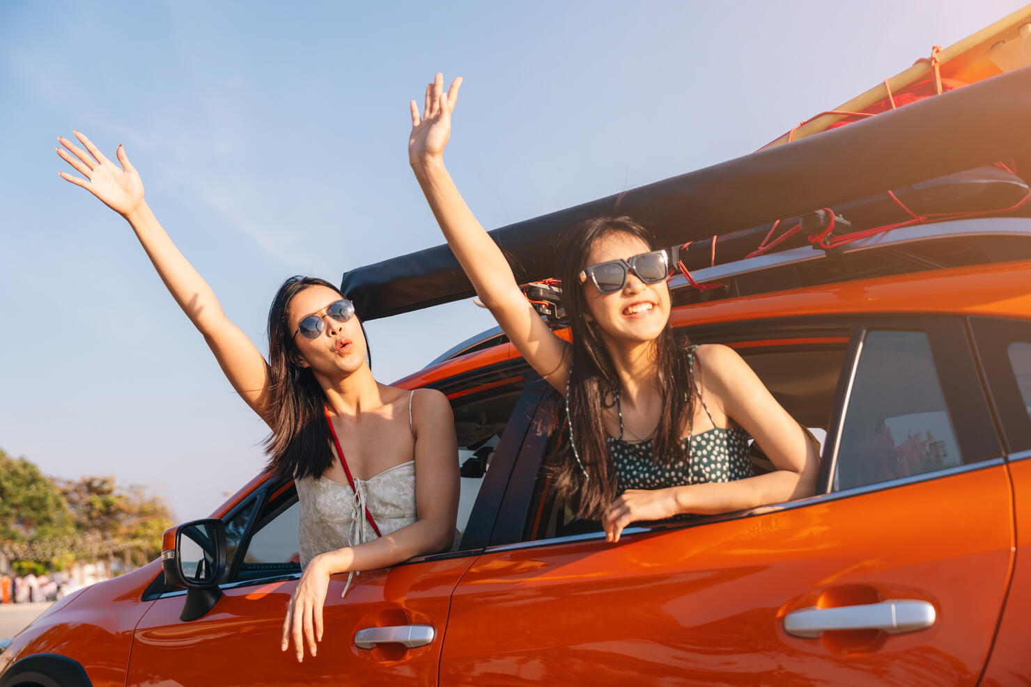 Young women head out while enjoying a summer road trip