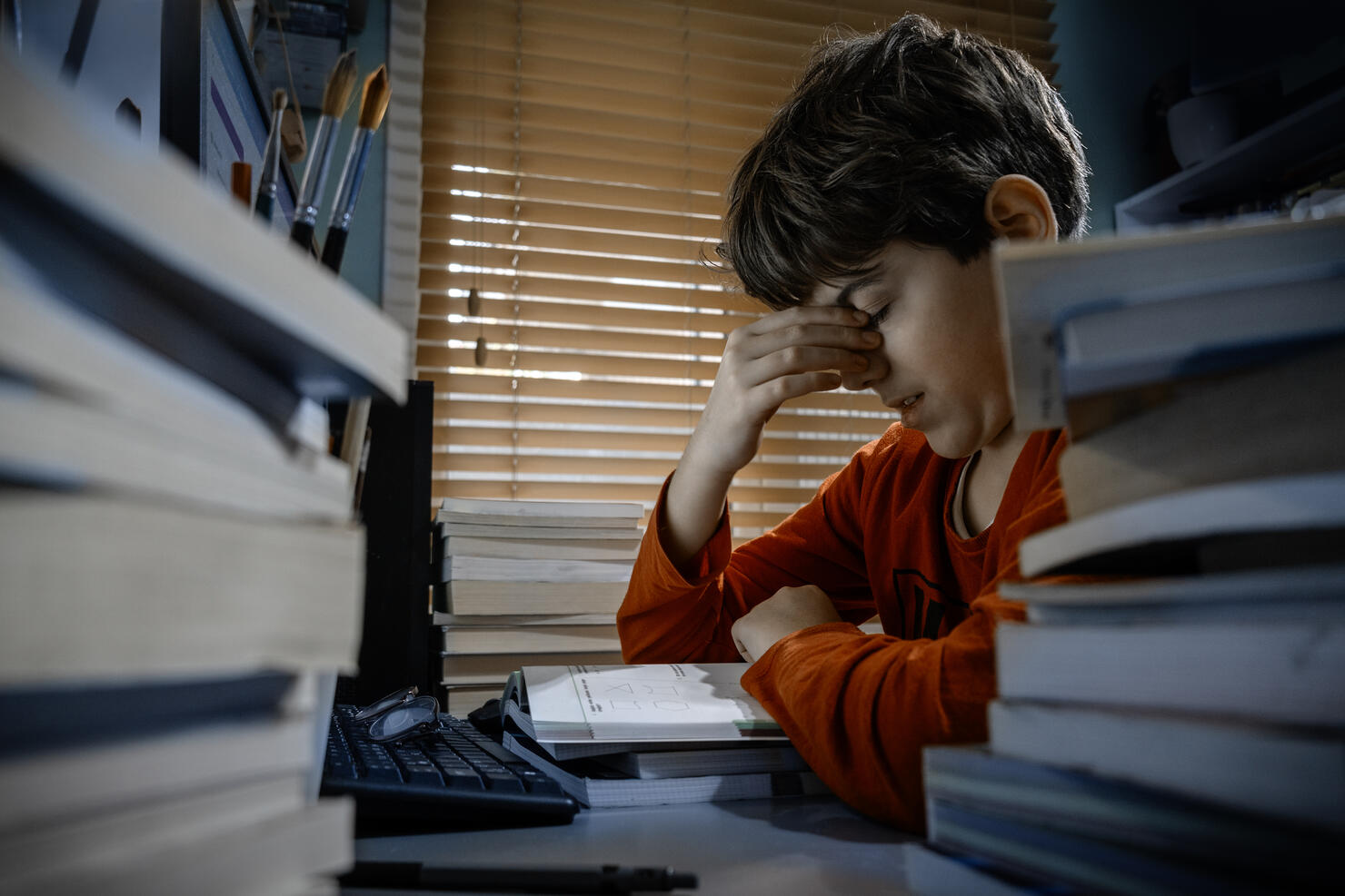 Tired student struggling with homework at home