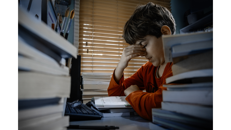Tired student struggling with homework at home