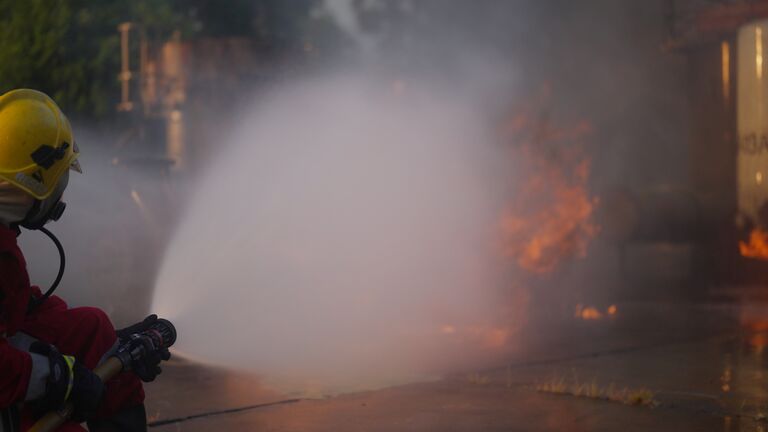 Firefighter training ,fireman using water  to fighting with fire flame , Thailand .